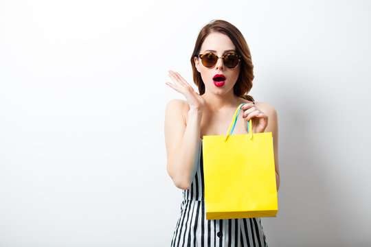 portrait of beautiful young woman with shopping bags on the wonderful white studio background