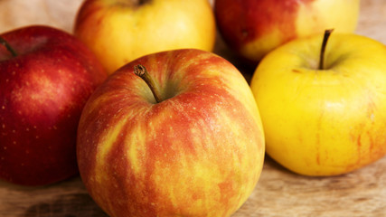 Naklejka na ściany i meble closeup of apples on a wooden plate