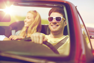 happy friends driving in cabriolet car