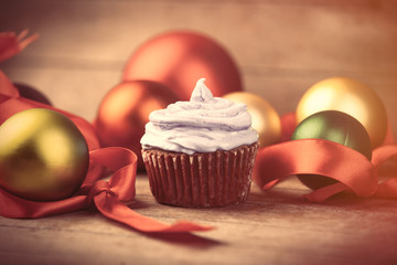 photo of tasty cupcake and Christmas decorations on the wonderful wooden brown background