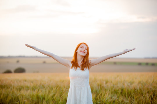 portrait of beautiful young woman on the wonderful wheat field background