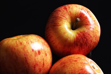 Juicy and ripe red apples isolated on a black background