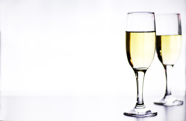 glass of white wine on a table on white background isolate