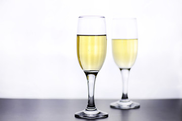 glass of white wine on a table on white background isolate