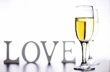 glass of white wine on a table on white background isolate