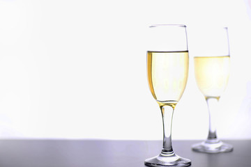 glass of white wine on a table on white background isolate