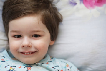 Portrait of a young child lying on a pillow