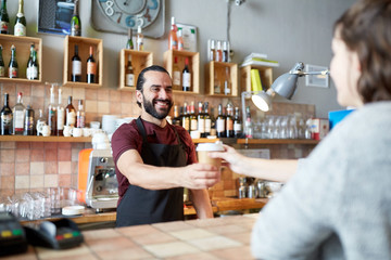 man or waiter serving customer in coffee shop