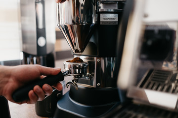 Hand of person making a fresh coffee