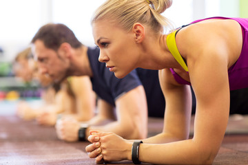 close up of woman at training doing plank in gym