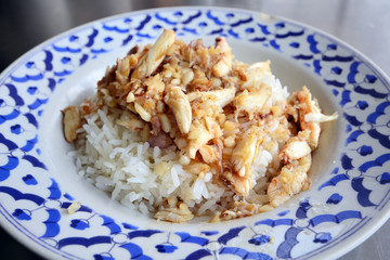 Crab meat fried with garlic top on rice in Thai style cuisine food