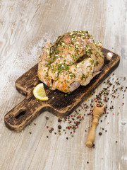 Chicken in marinade on a wooden board. 