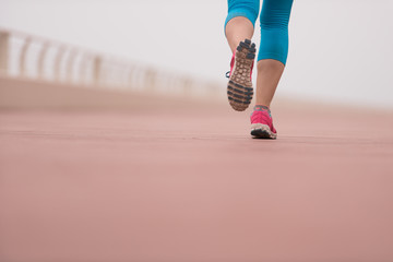 woman busy running on the promenade