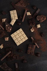 Assortment of different types of chocolate bars crashed into pieces