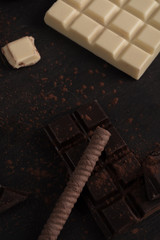 Chocolate bars and candies over wooden surface