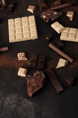 Big variety of chocolate bars crashed into pieces
