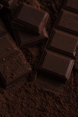 Dark chocolate tile pieces covered in chocolate powder