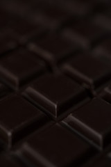 Close up of dark chocolate bar tiles