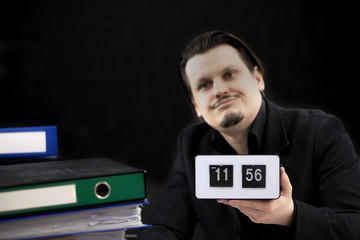 This worker looks annoyed and bored and is waiting for lunch which starts soon.