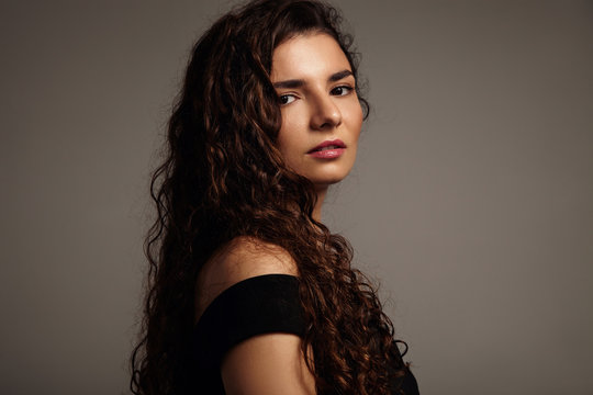 model with long curly hair in studio shoot