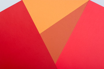 Color papers geometry flat composition background with pink,red, orange, grey tones.