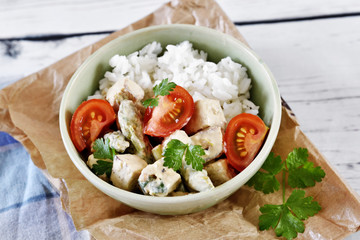 Delicious tofu dish with fresh tomatoes and green asparagus. High angle view.