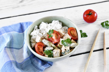 Delicious tofu dish with fresh tomatoes and green asparagus. High angle view.
