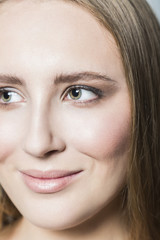 Fototapeta premium Face of young blonde beautiful girl with makeup and long hair