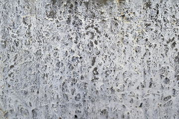 Grunge gray concrete wall with whitewash texture.