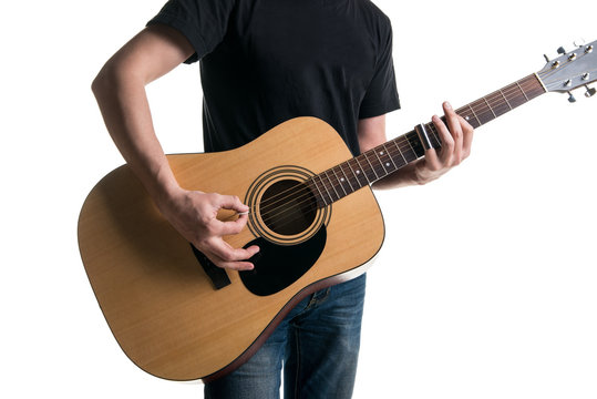 Guitarist in jeans and a black T-shirt, playing an acoustic guitar with a slider, on the left side of the frame, on a white background. Horizontal frame
