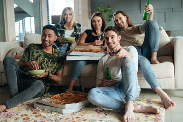 Image of happy five friends watching TV