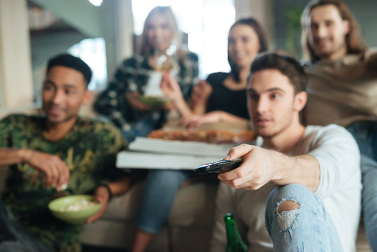 Blur image of a five friends sitting with pizza