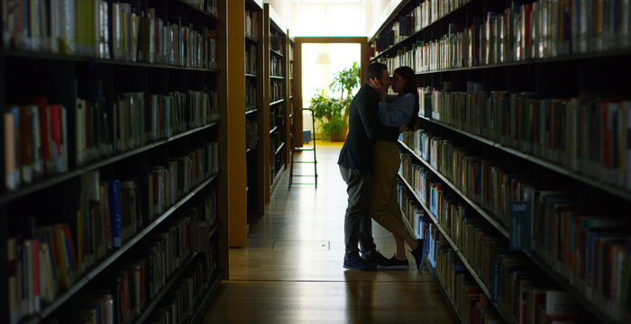 In a library, a couple in love, kissing and hug and carried away by passion  and love. Concept: Love, dream, kiss. Stock Photo | Adobe Stock