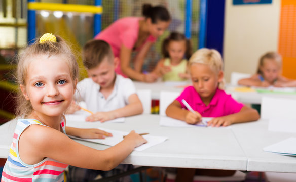 cheerful little school girl in class .
