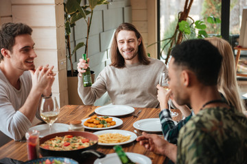 Group of people drinking beer and wine at the dinner