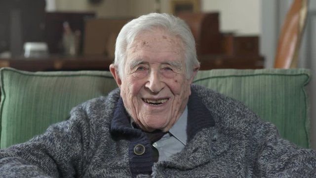 Portrait of grandfather laughing and smiling at the camera