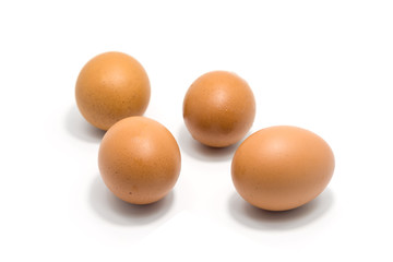 Four eggs isolated on white background.