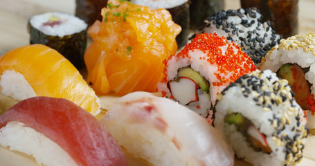 Macro shot of sushi, sashimi, uramaki and nighiri. typical Japanese dish consisting of rice, salmon or tuna,shrimp and fish eggs soaked in soy. Concept: Japanese restaurant, sushi, oriental tradition.