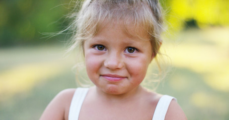 beautiful and healthy baby girl lifts thumb finger in approval. concept approval, nature and sustainability.	