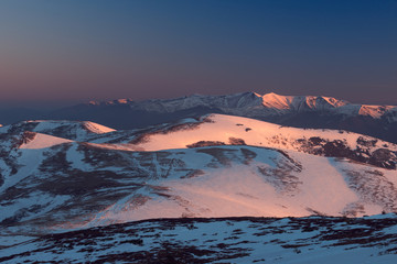 Fototapeta na wymiar Snowy hills in morning light. Carpathians, Ukraine