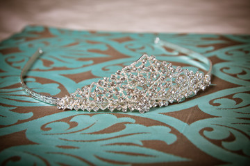 Wedding tiara on turquoise with brown background