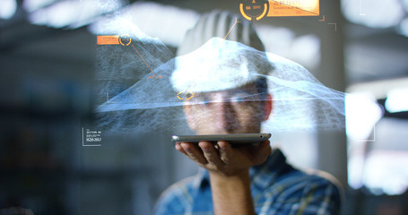 Fototapeta premium A worker uses a future technology platform to verify the design in holography and augmented virtual reality. Concept: future technology, multimedia technology, futuristic engineering.