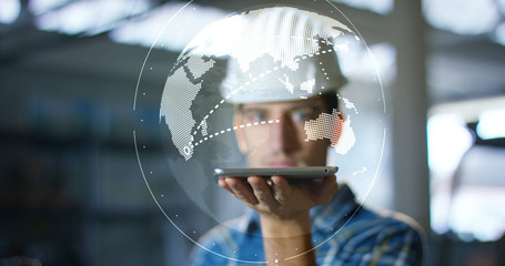 A worker uses a future technology platform to verify the design in holography and augmented virtual reality. Concept: future technology, multimedia technology, futuristic engineering. © Kitreel