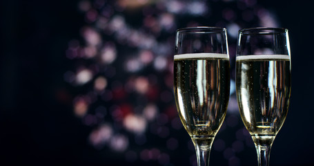 A champagne toast while in the background break out the fireworks. Concept: new year, love, holidays, party.