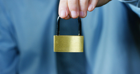 businessman show a padlock in safe sign with futuristic holographic about services and safety.concept of:password,Protection system files from technological hacker internet or banking system