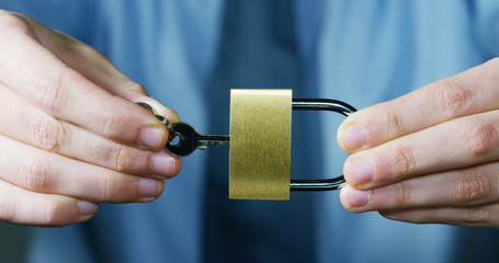 businessman show a padlock in safe sign with futuristic holographic about services and safety.concept of:password,Protection system files from technological hacker internet or banking system