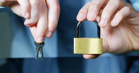 businessman show a padlock in safe sign with futuristic holographic about services and safety.concept of:password,Protection system files from technological hacker internet or banking system