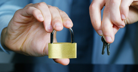 businessman show a padlock in safe sign with futuristic holographic about services and safety.concept of:password,Protection system files from technological hacker internet or banking system