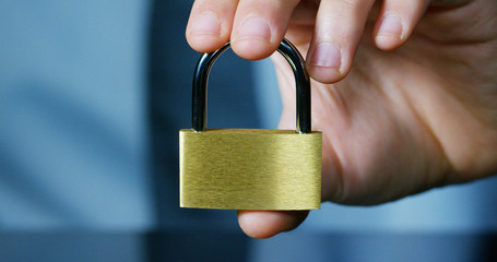 businessman show a padlock in safe sign with futuristic holographic about services and safety.concept of:password,Protection system files from technological hacker internet or banking system