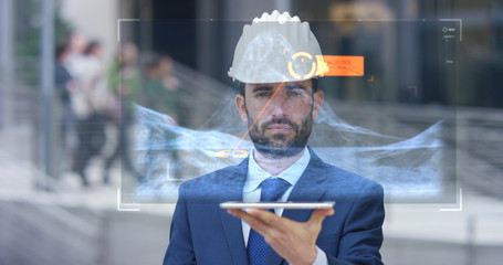 A engineer uses a future technology platform to verify the graphic in holography and augmented virtual reality. Concept: future technology, multimedia technology, futuristic engineering.	